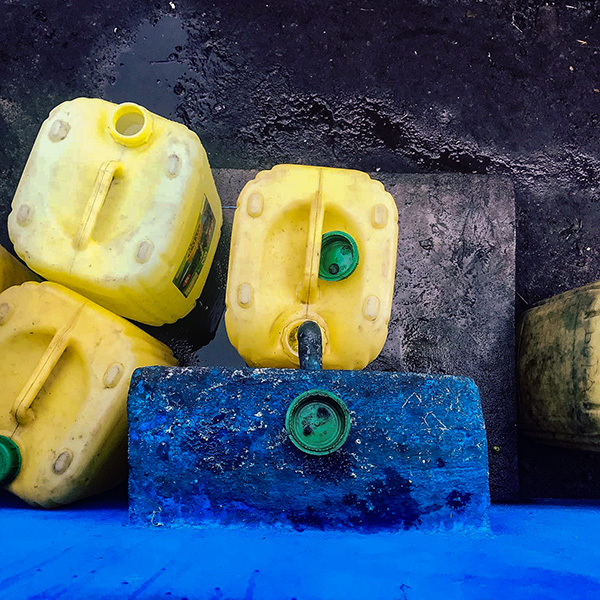 Jerry cans being filled from a community water kiosk