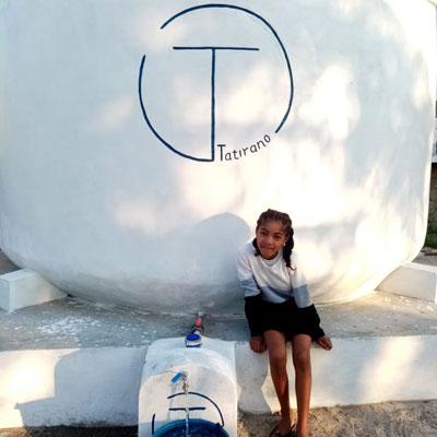 Finished Tatirano tank with water point and smiling girl