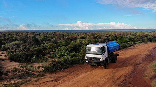 A water truck driving through an arid area in rural Madagascar